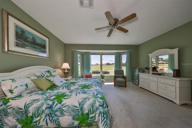 carpeted bedroom with ceiling fan and a textured ceiling