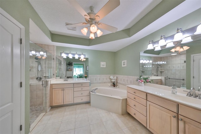 bathroom with vanity, shower with separate bathtub, a textured ceiling, and tile patterned floors