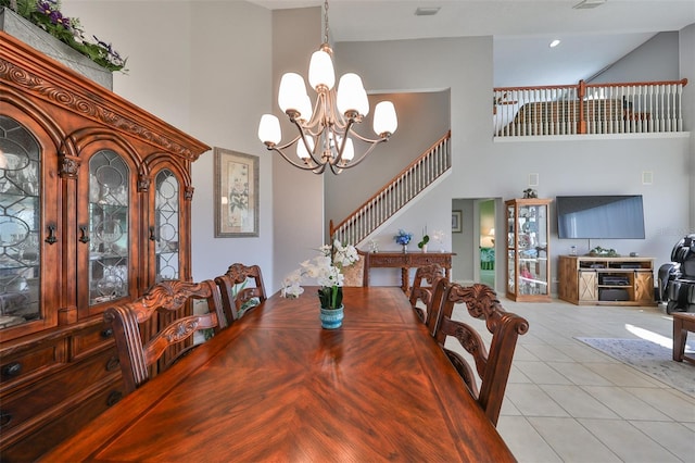 tiled dining area featuring an inviting chandelier and a towering ceiling