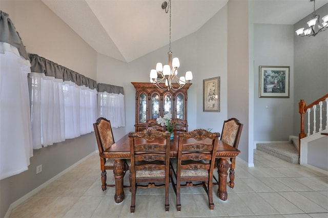 dining area with high vaulted ceiling, a chandelier, and light tile patterned floors