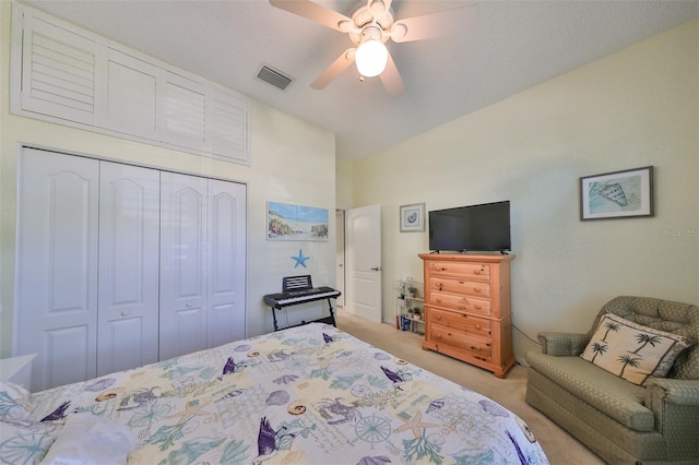 carpeted bedroom featuring ceiling fan and a closet