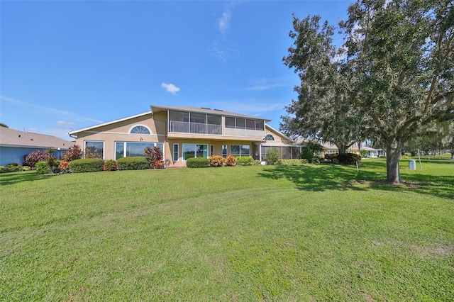 view of front of house with a sunroom and a front lawn