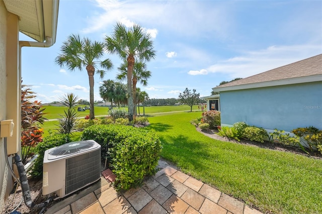 view of yard featuring central AC and a patio area