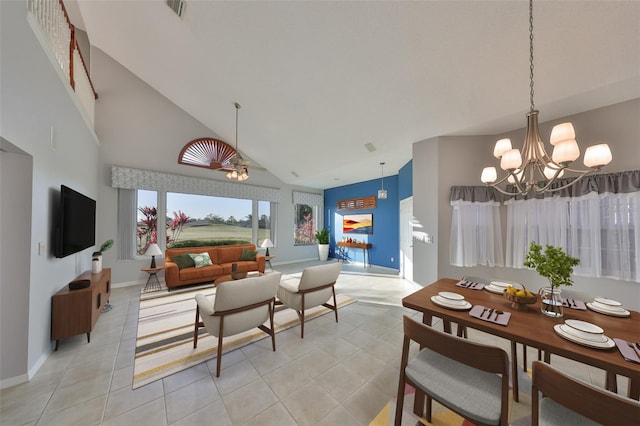 dining room with light tile patterned floors, baseboards, visible vents, high vaulted ceiling, and ceiling fan with notable chandelier