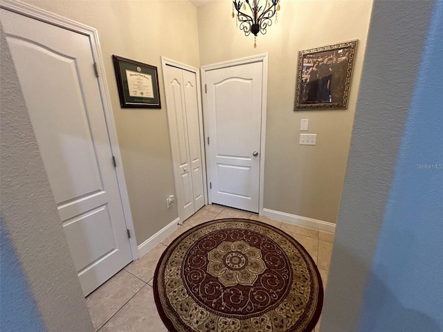 interior space featuring an inviting chandelier and light tile patterned floors