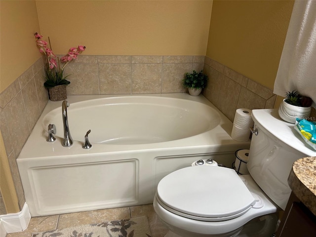 bathroom with a tub to relax in, vanity, and toilet