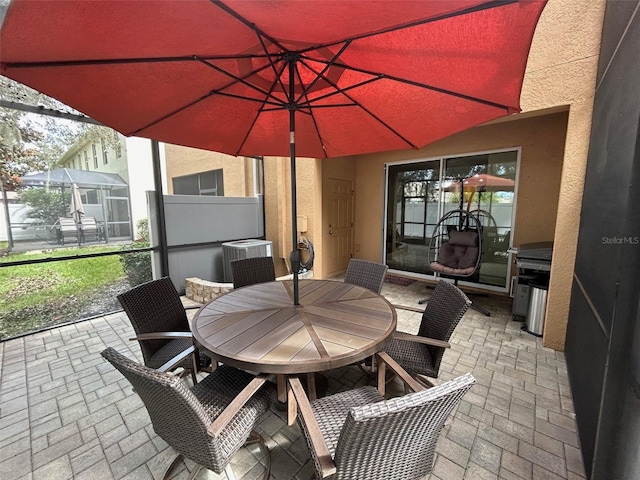 view of patio featuring glass enclosure