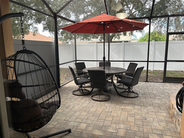 view of patio / terrace featuring glass enclosure