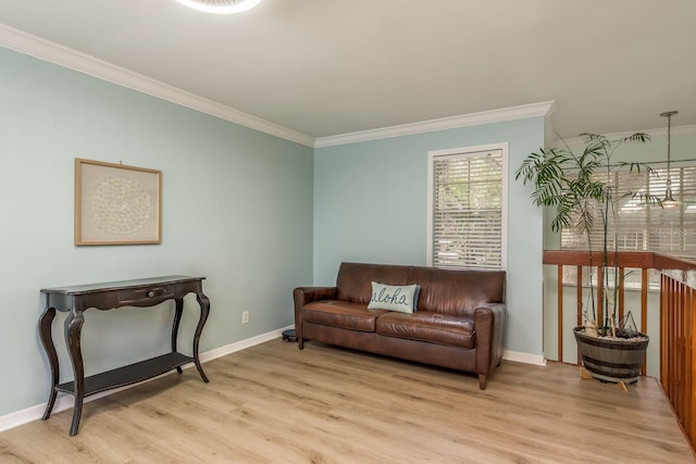 living area with ornamental molding and light hardwood / wood-style floors