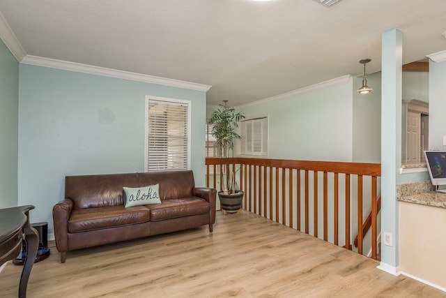 living room with ornamental molding and light hardwood / wood-style flooring