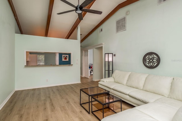 living room with beamed ceiling, ceiling fan, high vaulted ceiling, and light hardwood / wood-style floors