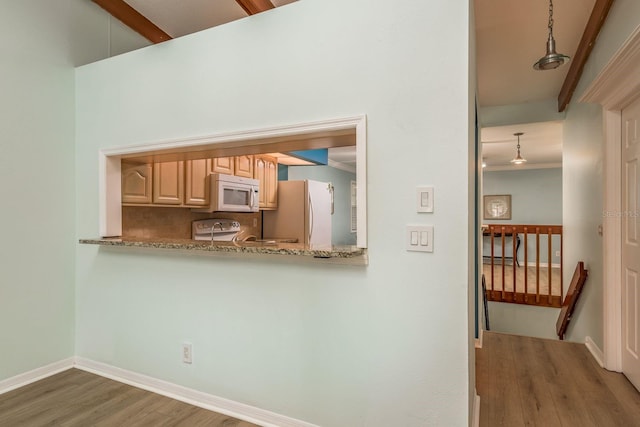 kitchen with crown molding, light brown cabinets, dark hardwood / wood-style flooring, pendant lighting, and white appliances