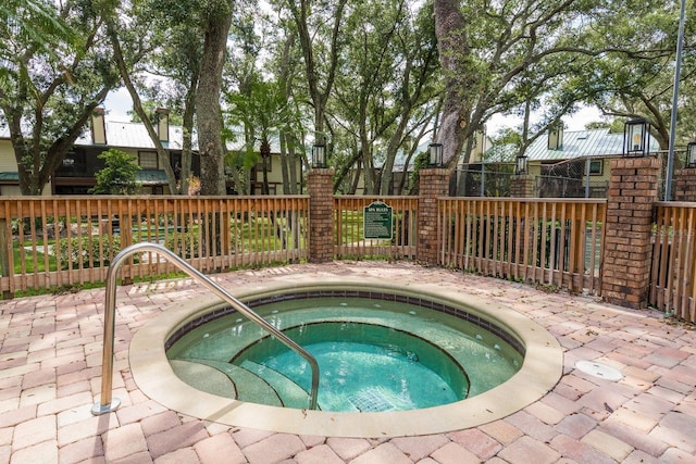 view of swimming pool with a hot tub and a patio area