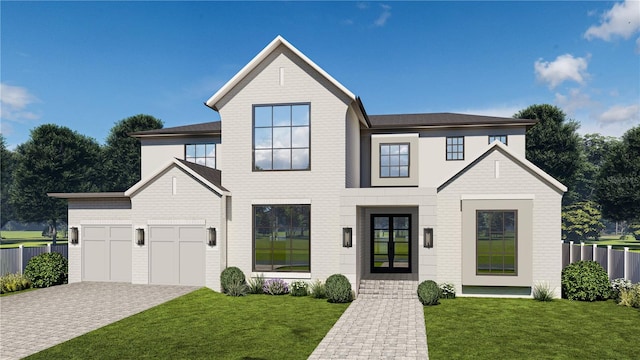 view of front of house featuring a garage and a front lawn