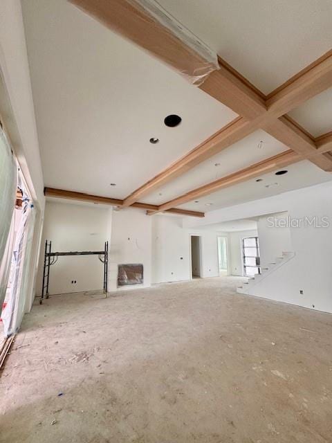 unfurnished living room featuring beam ceiling