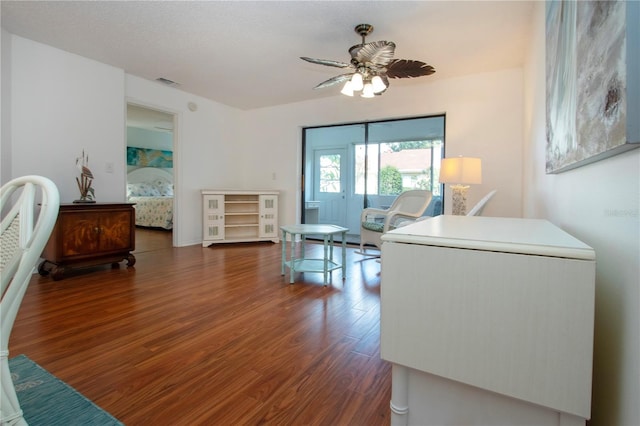 interior space with ceiling fan and dark wood-type flooring