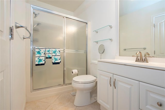 bathroom with walk in shower, vanity, tile patterned flooring, and toilet