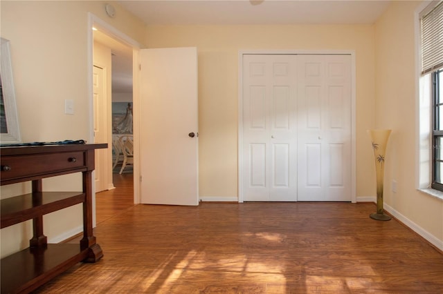 bedroom featuring wood-type flooring and a closet