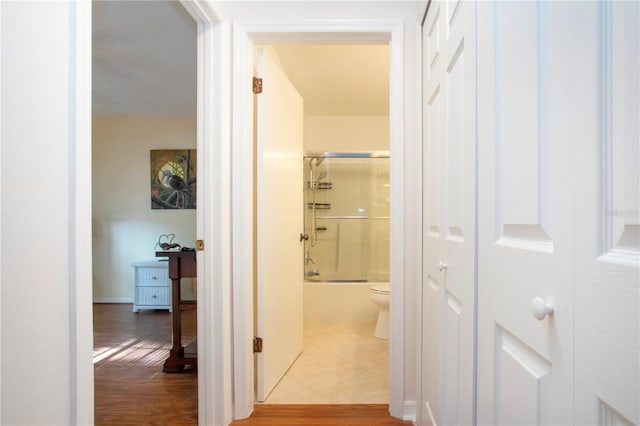 hallway with hardwood / wood-style flooring