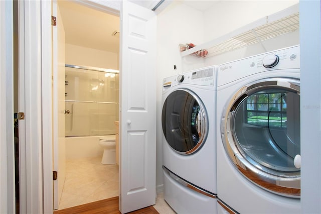 laundry area with tile patterned flooring and independent washer and dryer