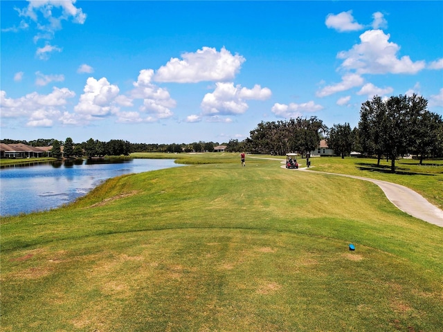 view of property's community featuring a lawn and a water view