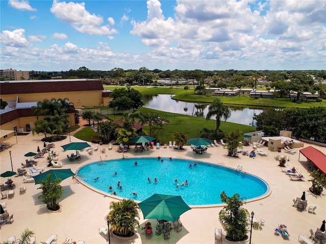 view of pool featuring a water view and a patio area