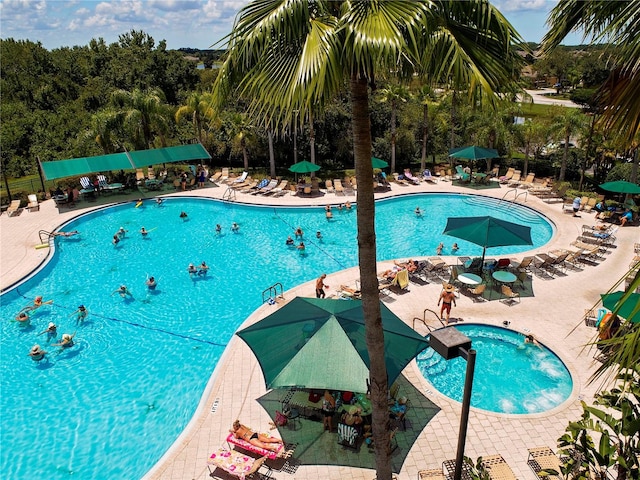 view of swimming pool featuring a patio area and a hot tub