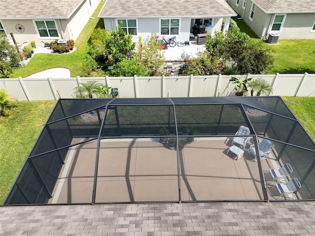 view of tennis court with a patio and a yard