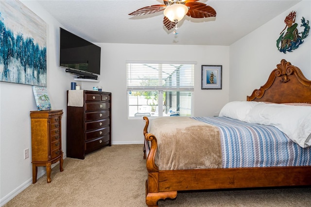 bedroom with baseboards, a ceiling fan, and light colored carpet