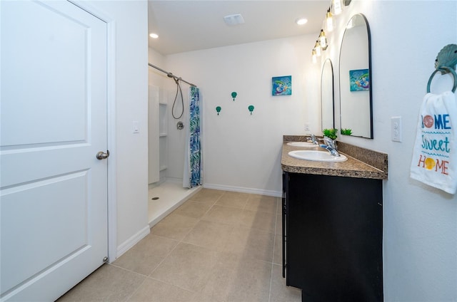 bathroom featuring vanity, curtained shower, and tile patterned flooring