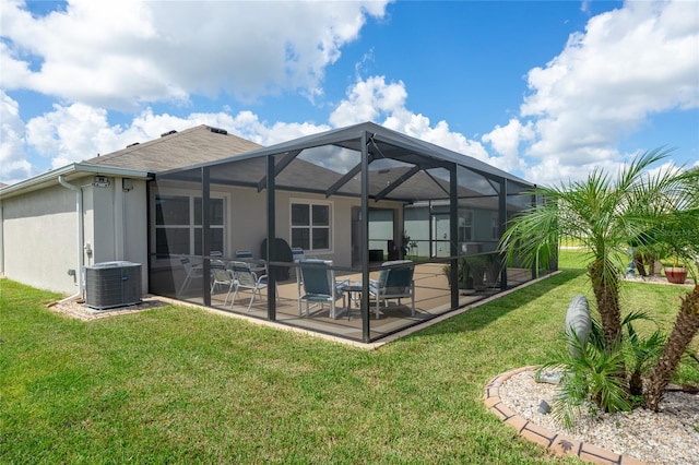 back of house with central AC, a lanai, a patio, and a lawn