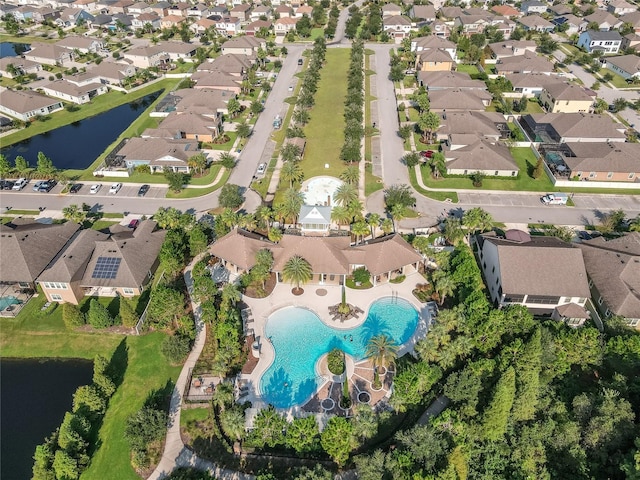 birds eye view of property with a water view and a residential view