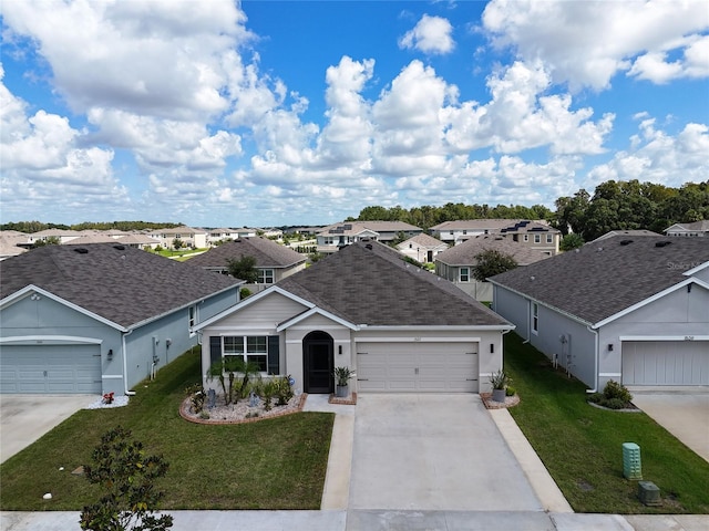 single story home featuring a shingled roof, a residential view, a front lawn, and concrete driveway