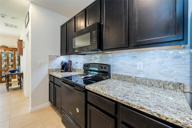 1523 Glen Grove Loop, Wesley Chapel, FL 33543 - kitchen featuring black appliances, backsplash, light tile patterned floors, and light stone counters