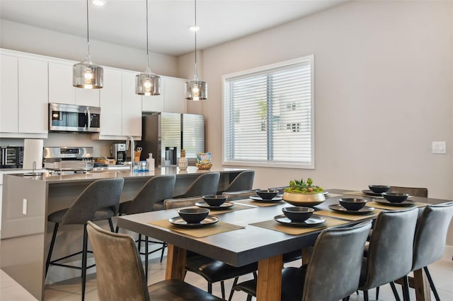 dining area featuring light tile patterned floors