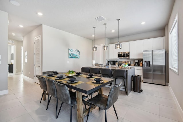 dining room featuring light tile patterned flooring and sink