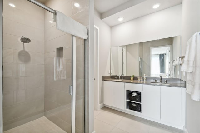 bathroom featuring tile patterned floors, an enclosed shower, and vanity