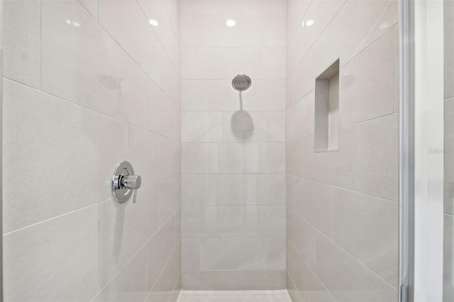 bathroom with a tile shower