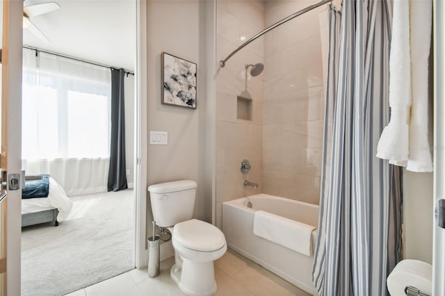 bathroom featuring shower / bathtub combination with curtain, toilet, and tile patterned floors