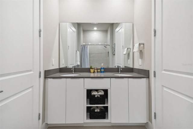 bathroom featuring vanity and a shower with door