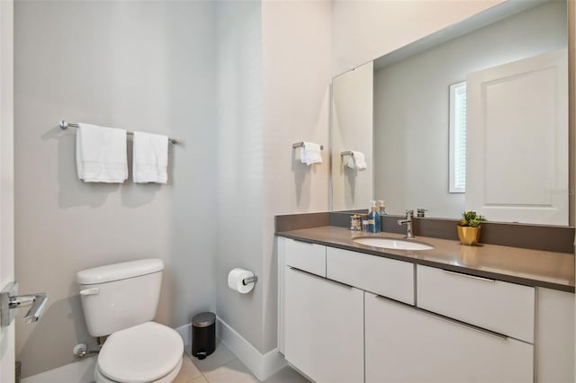 bathroom with vanity, toilet, and tile patterned floors