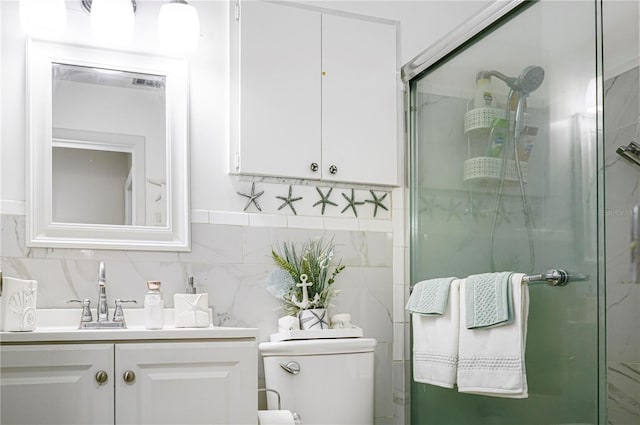 bathroom featuring vanity, toilet, an enclosed shower, and tasteful backsplash