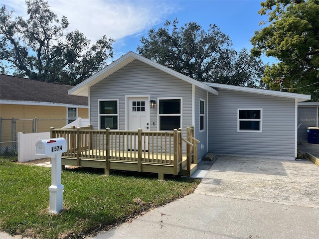 view of front of house with a front yard and a deck