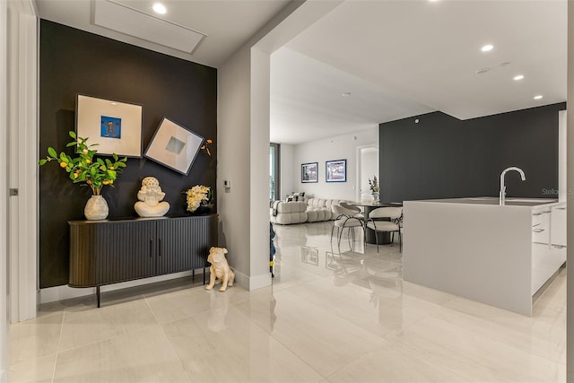 interior space featuring sink and white cabinets