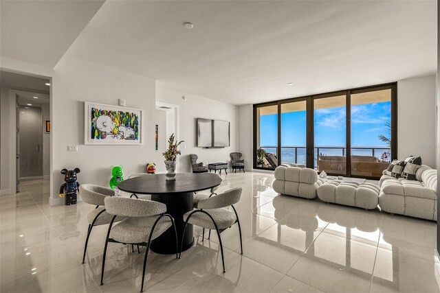 dining room with a wall of windows and a water view