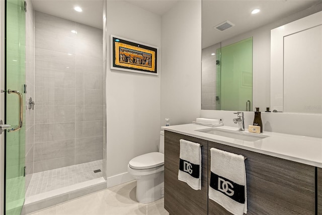 bathroom featuring vanity, a shower with shower door, toilet, and tile patterned flooring