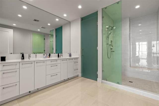 bathroom featuring walk in shower, vanity, and tile patterned flooring