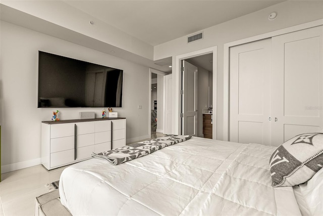 tiled bedroom with a closet