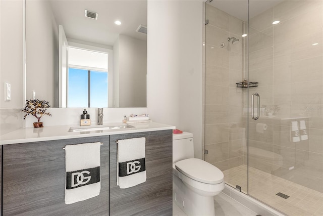 bathroom with an enclosed shower, tile patterned floors, vanity, and toilet