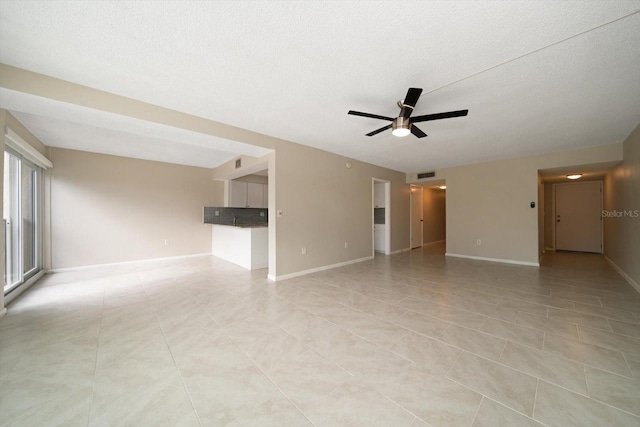 unfurnished room featuring ceiling fan, light tile patterned floors, and a textured ceiling